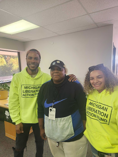 three people standing together smiling